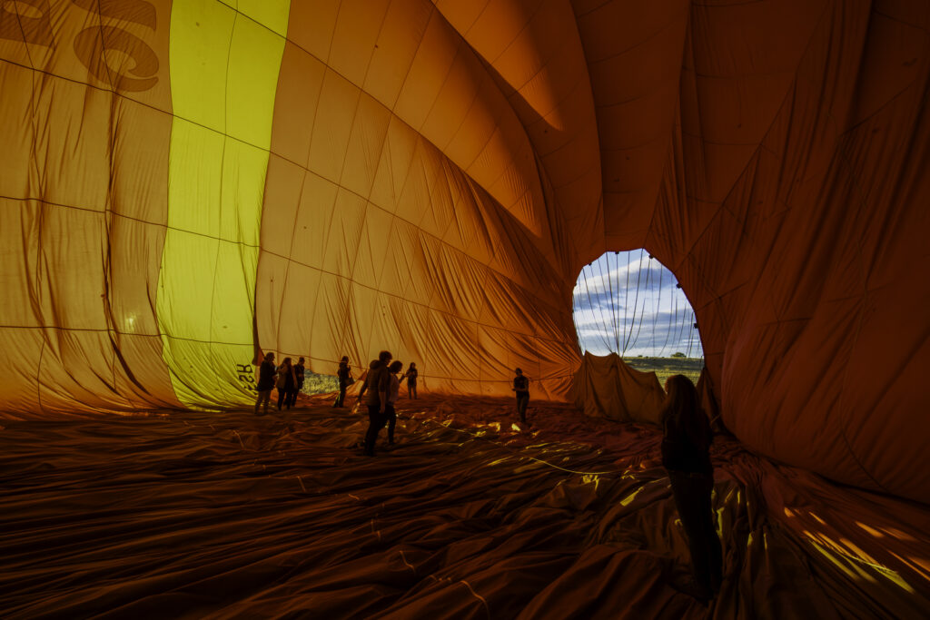 Experience an unforgettable adventure in Alice Springs with Outback Ballooning! After an exciting morning flight, invited visitors get the unique opportunity to walk inside the enormous hot air balloon as it deflates and is packed up. Witness the incredible process up close and enjoy the stunning backdrop of Australia's outback. Perfect for anyone looking to add a special touch to their journey!